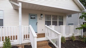 A house with a light blue door, number 903, and a white porch with a railing. - The Cowgirl Cottage- Bright 3BR in The Nations + Close to Broadway & Dining (Nashville)