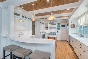 A modern kitchen with white cabinetry, a wooden ceiling, and pendant lighting. - Beautiful Downtown Telluride Home | Steps to Gondola & Downtown, Firepit, Views (Telluride)