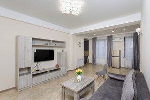 Economy Cottage | Living area | 50-inch flat-screen TV with cable channels - Apartment by Luxe Group XO222 (Yerevan)