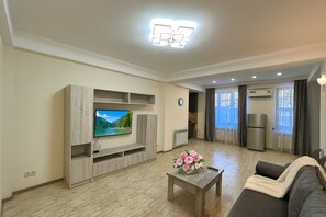 Economy Cottage | Living area | 50-inch flat-screen TV with cable channels - Apartment by Luxe Group XO222 (Yerevan)