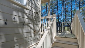 A wooden staircase leading to a porch with a railing, surrounded by trees. - 2 Pools 1 heated, Private Beach Access, New Shops & Restaurants! NEW LISTING! (Santa Rosa Beach)