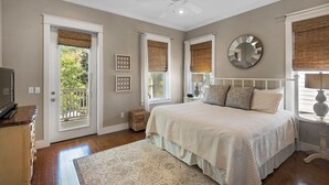 A bedroom with a large bed, a ceiling fan, and a view of the outdoors through a sliding door. - 2 Pools 1 heated, Private Beach Access, New Shops & Restaurants! NEW LISTING! (Santa Rosa Beach)