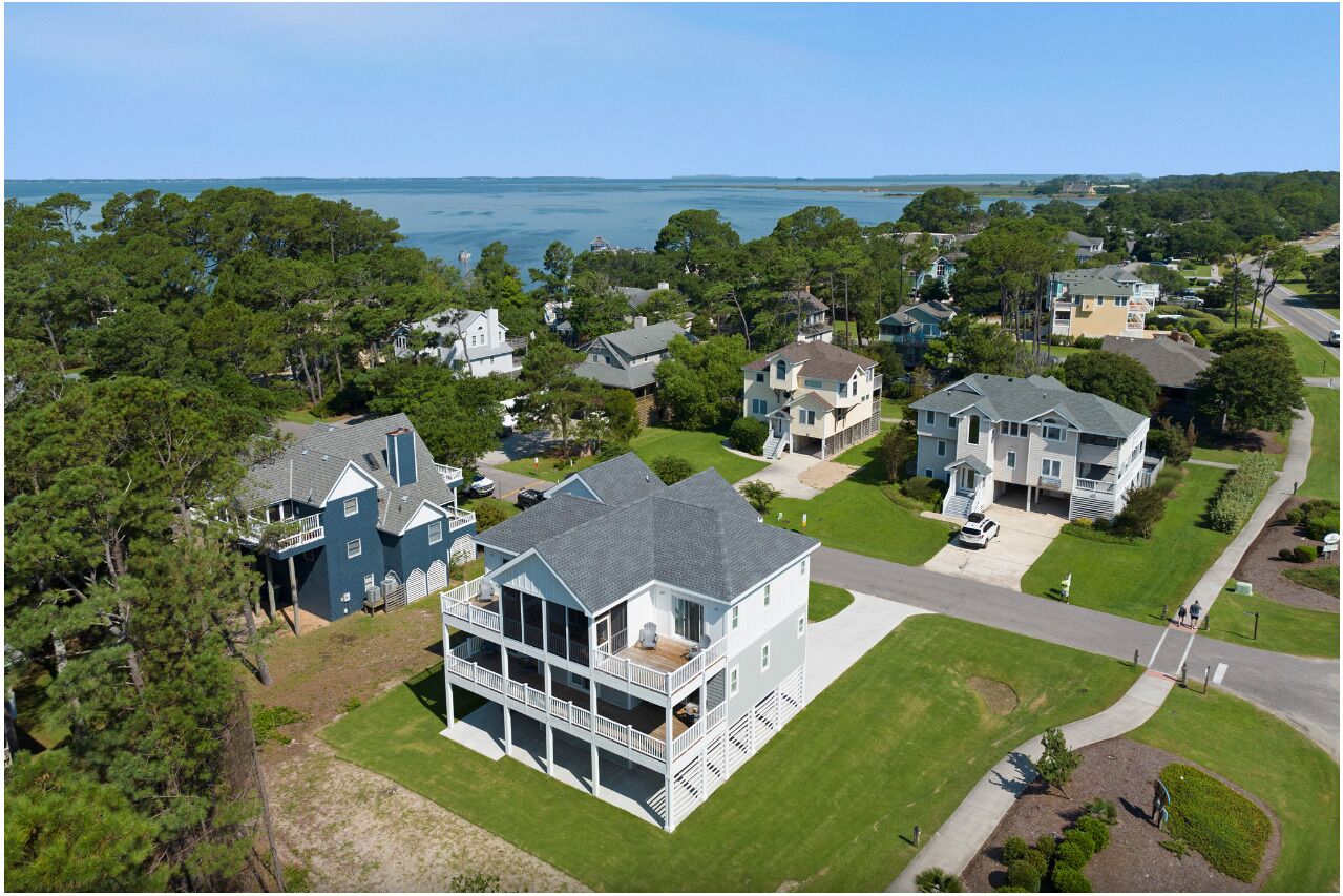 A coastal residential area with houses featuring balconies and waterfront views.