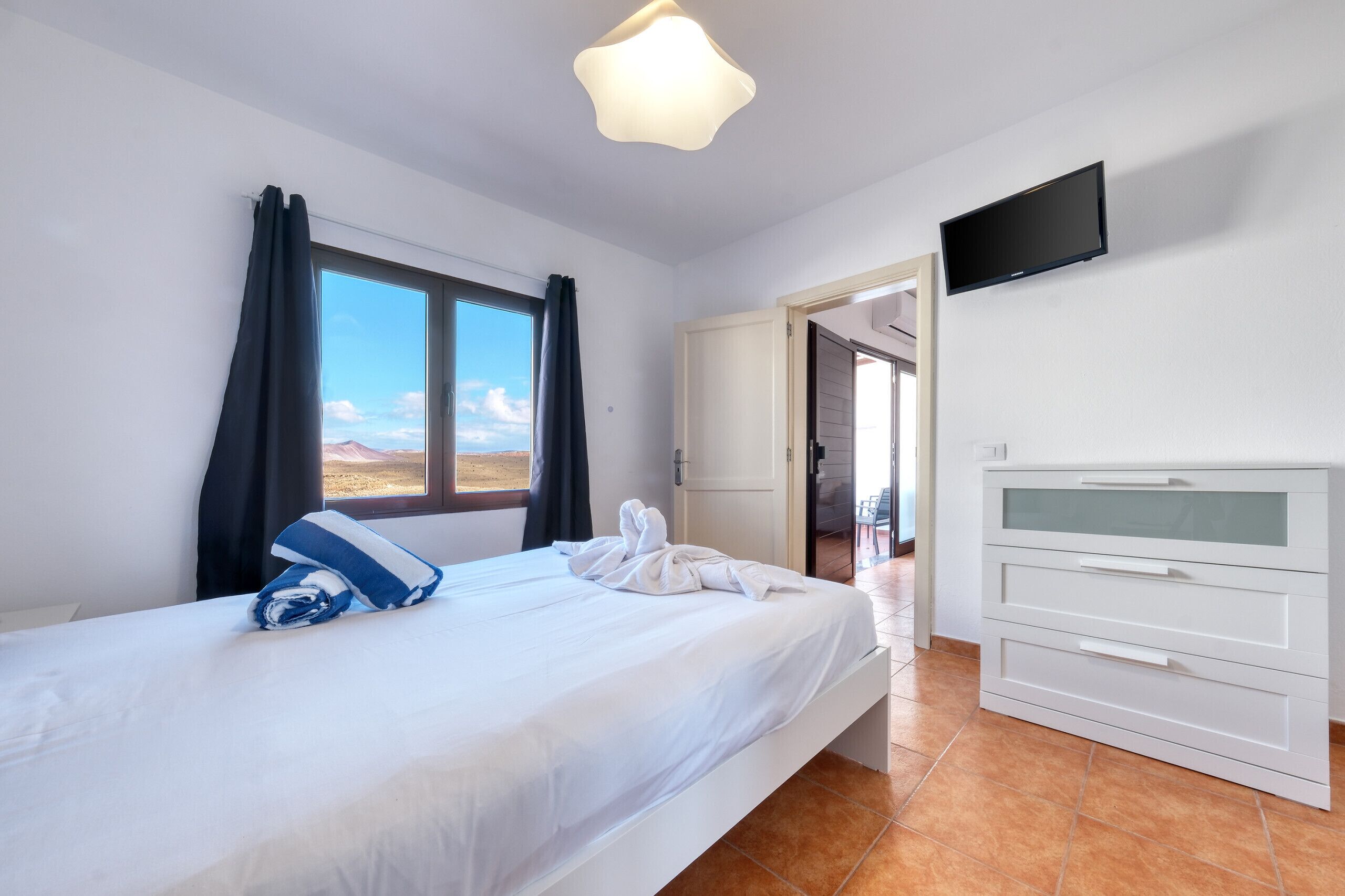 3 dormitorios, caja fuerte, escritorio y tabla de planchar con plancha