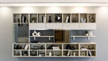 A modern interior with a built-in shelving unit displaying various decorative items and books.