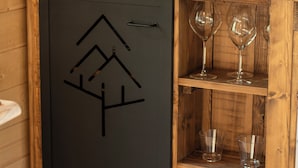 A compact kitchen with a coffee machine, a fruit bowl, and wine glasses on shelves. - Les Lodges du Quercy (Les Pechs du Vers)