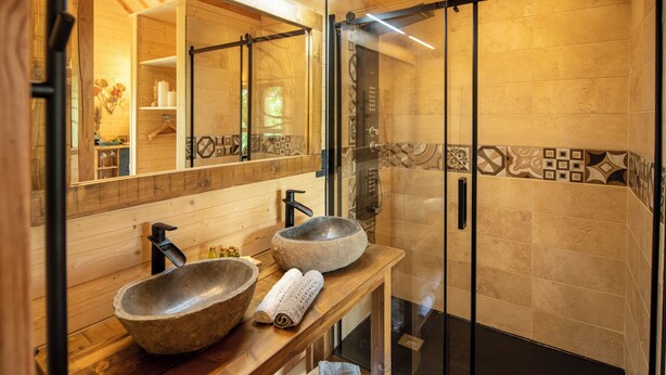 A wooden vanity with two large stone bowls and a mirror. - Les Lodges du Quercy (Les Pechs du Vers)