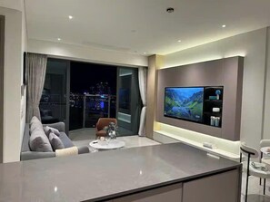 Presidential Suite, 2 Bedrooms, Club Lounge Access, River View | Living area | 65-inch Smart TV with cable channels, fireplace, Netflix - Miso Luxstay The River Ho Chi Minh City (An Khanh)