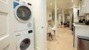 A modern kitchen with white cabinets, a microwave, and a coffee machine. - 2 bedroom sanctuary in the middle of Washington DC (Washington)