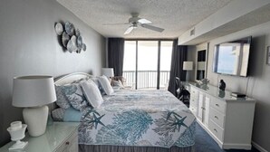 A bedroom with a bed, dresser, nightstand, and a ceiling fan. - 14th floor 4BR/3BA Ocean Front Condo: Stunning Views & Upgraded Ocean Bay Club (North Myrtle Beach)