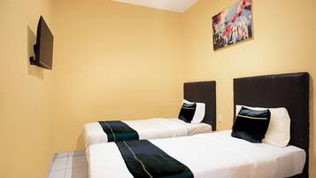 A hotel room with two beds, a painting on the wall, and a flat-screen TV mounted on the wall.