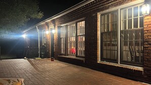A brick building with large windows and a patio area. - Massey's in the Park (Vicksburg)