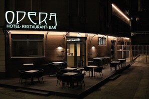 An outdoor seating area of a hotel, restaurant, and bar named "Opera." - Boutique Hotel OPERA (Rijeka)