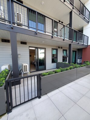 A modern multi-story residential building with balconies, large windows, and outdoor air conditioning units. - Kelowna, Sweet Suite Cultural District Pets OK (Kelowna)