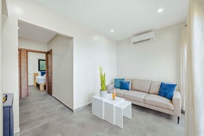 A modern living room with a sofa, a coffee table, and a potted plant. - Pool&Jacuzzi 18 Guests Complex Sea La Vie 10Br|5Ba (aruba)