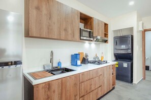A modern kitchen with wooden cabinets, stainless steel appliances, and a built-in microwave. - Pool&Jacuzzi 18 Guests Complex Sea La Vie 10Br|5Ba (aruba)