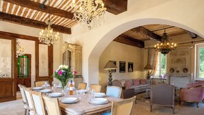 A dining area with a wooden table set for six, surrounded by vintage chairs. - Bastide of the Rose Comtesse – The Art of Intimate Luxury in Provence (Ventabren)