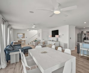 A modern, open-plan living space with a dining area, kitchen, and seating area. - Marvelous 4-bedroom Oceanfront home in Harbor Island (Harbor Island)