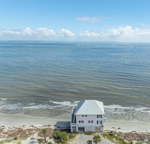 A coastal house with a metal roof, situated on a sandy beach with ocean views. - Marvelous 4-bedroom Oceanfront home in Harbor Island (Harbor Island)
