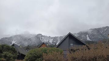 A row of houses with a mountainous backdrop.