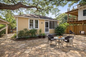 A house with a stone patio, outdoor seating, and a covered porch. - Tybee Island Sunrise (Tybee Island)