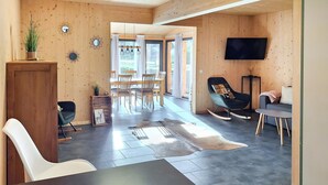 A modern interior with a dining area, a living space, and a TV mounted on the wall. - 3 bedroom pet friendly home in Hohentauern (Hohentauern)