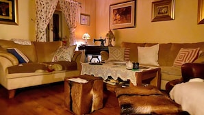 A cozy living room with a sofa, armchair, and ottoman, a sewing machine, and a lace tablecloth. - 1 bedroom cozy home in Duga Resa (Duga Resa)