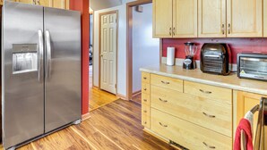 A kitchen with a stainless steel refrigerator, wooden cabinets, a toaster, and a blender. - Near Beaches, Base & Bay! Hampton Home w/ Backyard (Hampton)