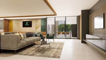 A modern hotel lobby with a sofa, chairs, a TV, and a view of the outdoors.