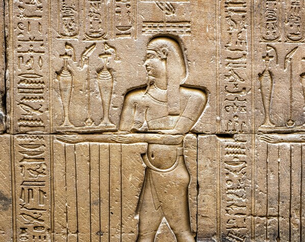 A stone carving with hieroglyphics and a figure of a person. - Hotel Indigo Gloucester The Forum By IHG (Gloucester)