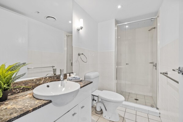 A modern bathroom with a sink, toilet, and glass-enclosed shower. - Chevron Renaissance - 2 Bed 2 Bath - 3295 - 3 night - 2 bed 2 bath Apartment (SURFERS PARADISE)