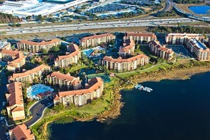 A resort with multiple buildings, a swimming pool, and a body of water. - Apartment with 3 bedrooms (one lock off) at Westgate Lakes Resorts and Spa, Orlando, sleeps up to 12 people. (Orlando)