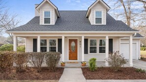 A two-story house with a gabled roof, a front porch, and a garage. - Home in Pooler w/ FirePit and Game Room (Pooler)