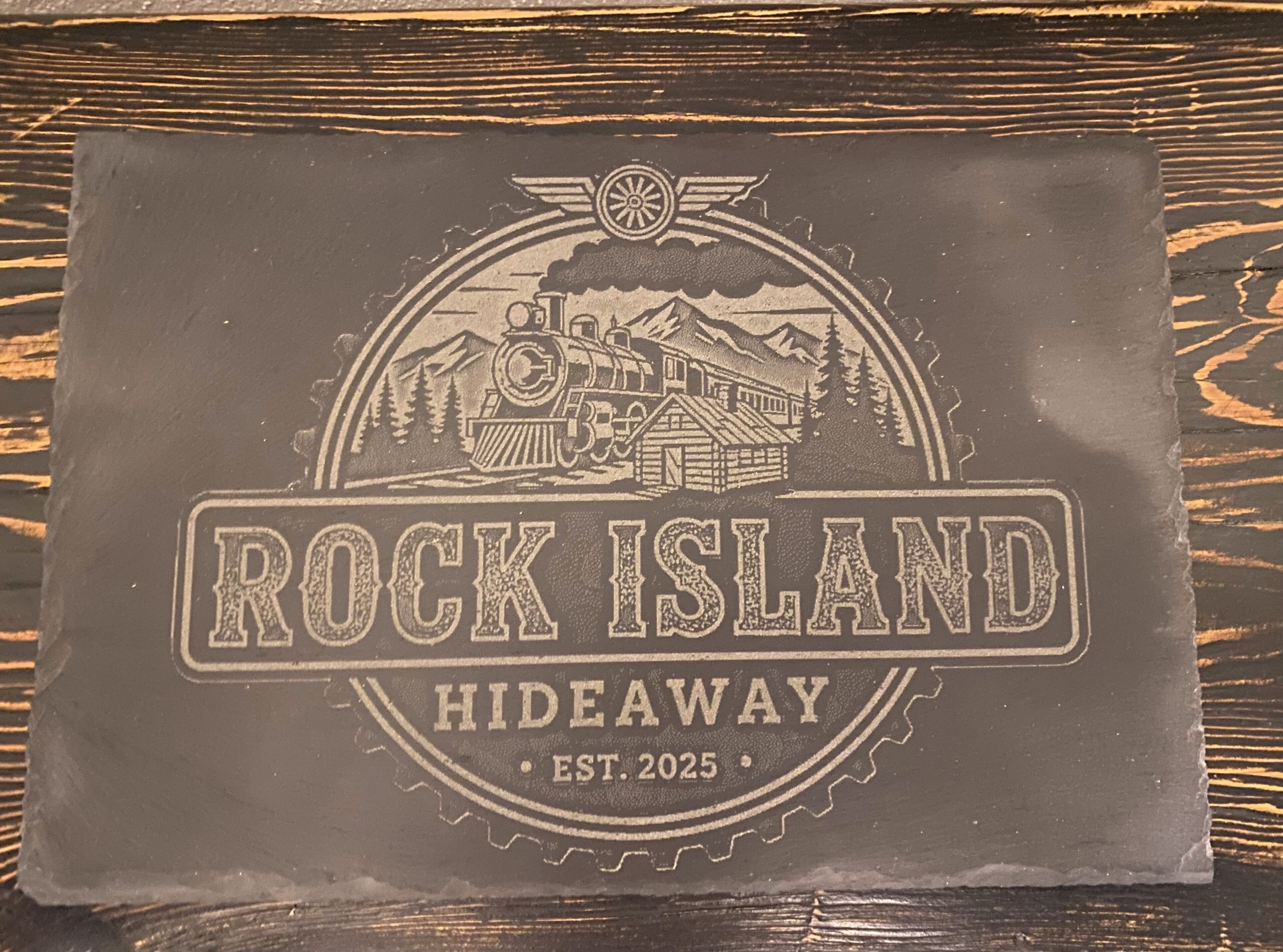 A logo with a train, mountains, and the text "ROCK ISLAND HIDEAWAY EST. 2025".