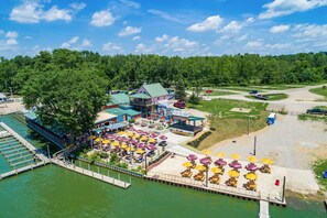 A lakeside hotel with outdoor seating and a dock. - The Heron House | Peaceful Lakeside Retreat (Millersport)