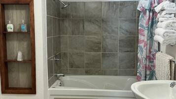 Deluxe Room, 2 Queen Beds, Non Smoking | Bathroom | Shower, hair dryer, towels, soap