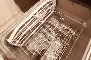 An empty dishwasher with a transparent rack and a control panel. - Haneda House II (Tokyo)