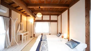 A room with a bed, bedside table, and a mirror.