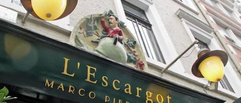 A building with a sign that reads 'L'Escargot Marco Pierre White.'