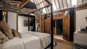A bedroom with a canopy bed, wooden beams, a television, and a view of the outdoors. - Bloom Resort Bali by BaliSuperHost (Bali)