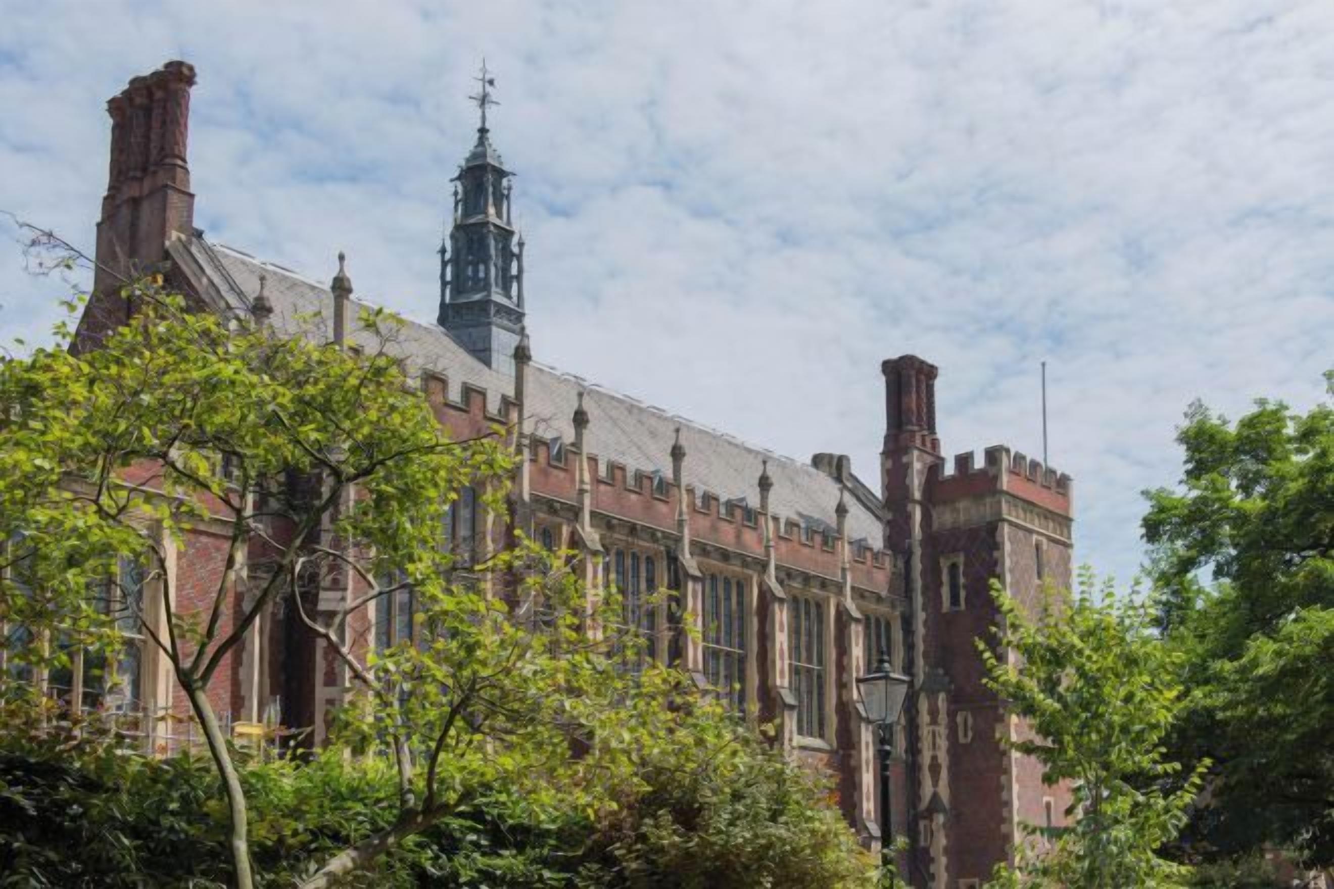 A historic building with large windows and a prominent tower.