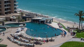 A resort with a large pool area, multiple swimming pools, and a beach. - Luxury Beachfront Stay at Las Palomas A702 Phase 1 – Stunning 2BR Escape on Sandy Beach (Puerto Peñasco)