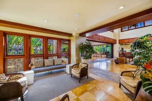 A spacious lobby with a seating area, large windows, and indoor plants. - Wailea Beach | Oceanfront 3 BR | Car Incl. w/ 6+ Nights | WBV-PH505 by KBM (Wailea)
