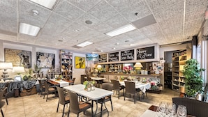 A restaurant interior with tables, chairs, a bar area, and a ceiling with a unique texture. - Full Duplex on Longboat Key, Walk to the Gulf + Cedars East Club Access (Longboat Key)