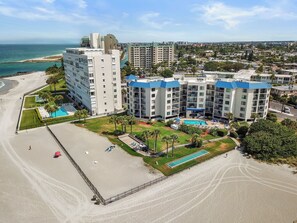 A beachfront hotel with multiple buildings, a swimming pool, and a beach area. - 🌊 New Listing! Caprice Resort Unit #305 – Gulf Front Comfort with Private Balcony (Saint Pete Beach)