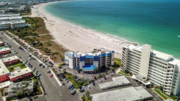 A coastal hotel with a beach view, parking, and a large building with a blue roof. - 🌊 New Listing! Caprice Resort Unit #305 – Gulf Front Comfort with Private Balcony (Saint Pete Beach)