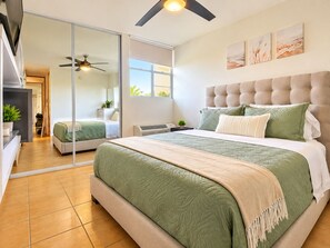 A modern bedroom with a large bed, a ceiling fan, and a sliding glass door leading to a bathroom. - Nido Azul -Oceanview Condo 2B/2B + 2 Parking +Wifi. Cabo Rojo-Puerto Rico (Boquerón)
