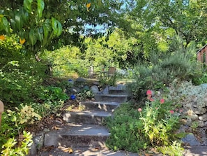 A stone staircase surrounded by lush greenery and flowers. - Bright Studio in downtown Fremont (Seattle)