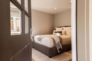 A bedroom with a bed, a window, and a door. - 5-Bedroom Park City Old Town Daly Overlook with stunning mountain views. (Park City)