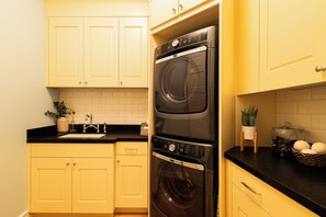 A kitchen with a double oven, a sink, and yellow cabinets. - 5-Bedroom Park City Old Town Daly Overlook with stunning mountain views. (Park City)
